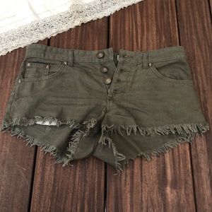 green frayed shorts